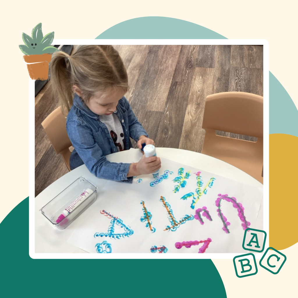 Preschool child building drawing on their own.